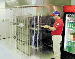 Clear high-temperature pizza oven curtains made from heat-resistant PVC strips, protecting kitchen staff and containing heat in a commercial pizza kitchen.