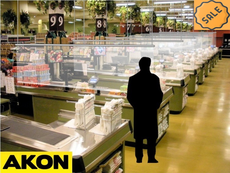 Clear hanging divider curtains suspended from overhead tracks to separate people and create distinct zones with visibility in a supermarket baggage area.