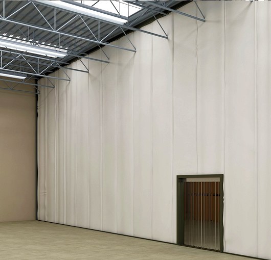 v=White insulated industrial curtain wall with a strip curtain pedestrian access opening for temperature separation in a large warehouse space.