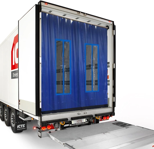 Blue insulated dock door curtains with clear vision panels, designed for temperature control and energy efficiency at a loading bay.