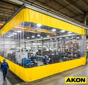 Heavy-duty fabric divider curtains installed inside an industrial factory to separate work areas.