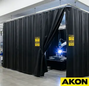 Laser barrier curtains installed in an industrial facility to block and contain laser radiation from spreading to adjacent work areas.