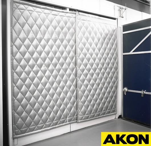 Clear industrial PVC curtain wall used for warehouse temperature separation while maintaining visibility and natural light flow.