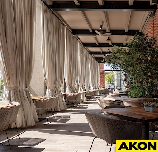 AKON Fabric curtains designed to enhance and protect outdoor restaurant patio spaces