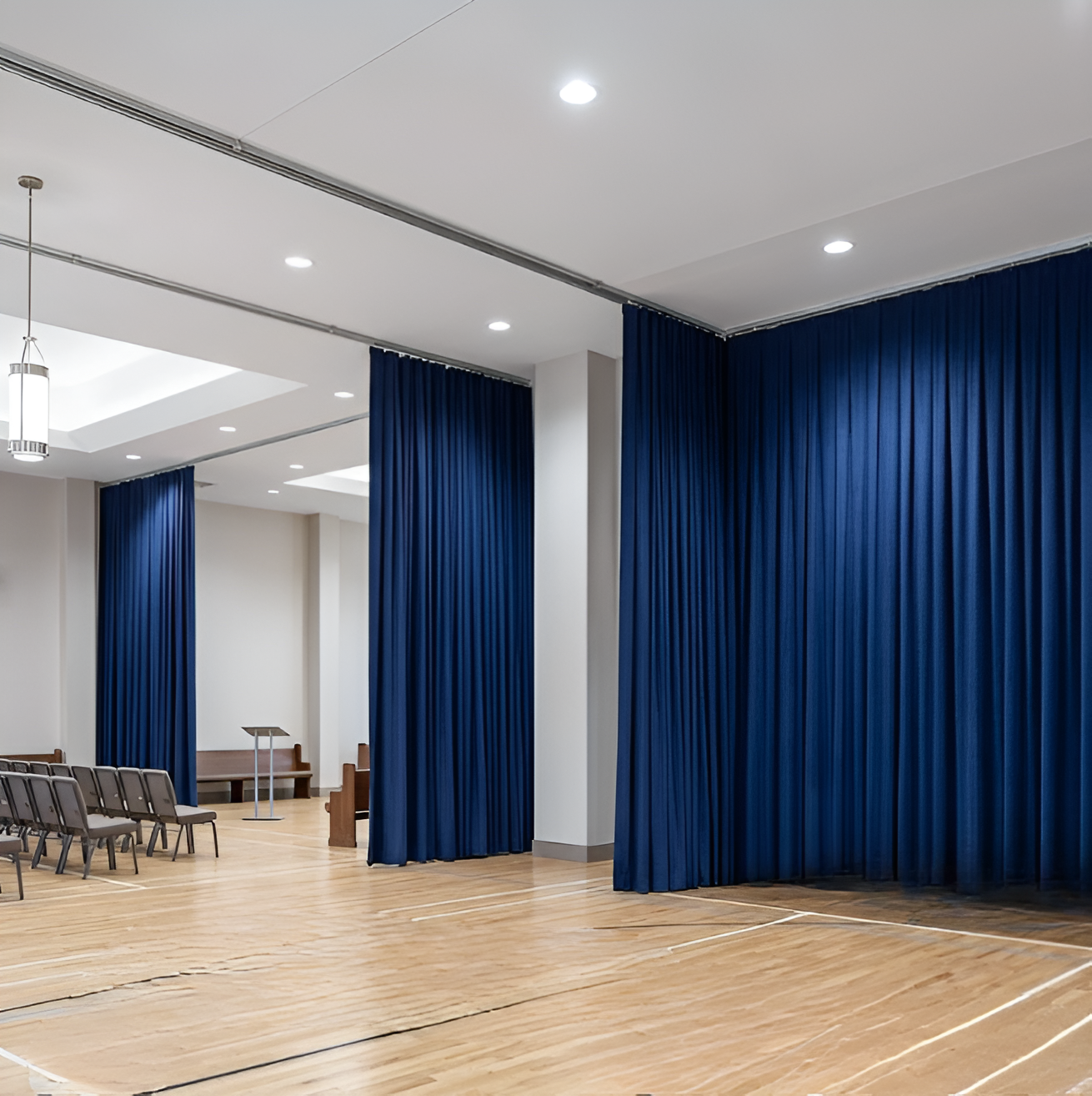 Blue church divider curtains creating partitions inside a multi purpose worship hall
