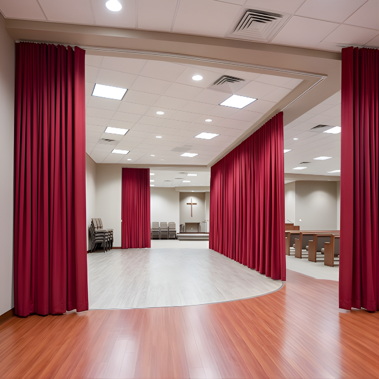 Red church divider curtains used to separate spaces inside a modern church hall