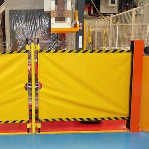 Sliding PVC strip curtains on a galvanized steel track for industrial doorways, providing clear separation while allowing easy movement through the opening.