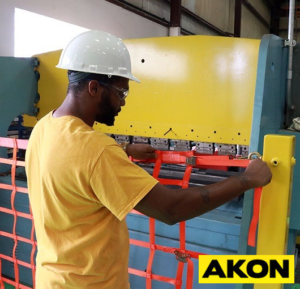 Industrial safety net with attachment straps installed to catch falling objects or debris in a warehouse or work area.