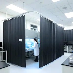Retractable curtain divider installed in an industrial laboratory to separate work areas.