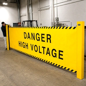 Retractable industrial barricade extended across a facility aisle to block off a hazardous or restricted work zone.