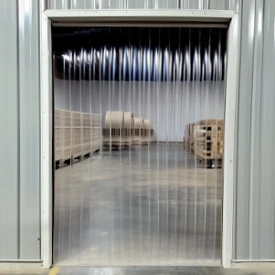 PVC strip doors and curtains installed in an industrial or commercial doorway to control temperature and separate work zones.
